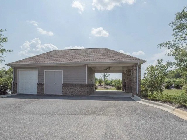 a garage with a roof and a driveway at Century HomePlace, Prattville, 36066