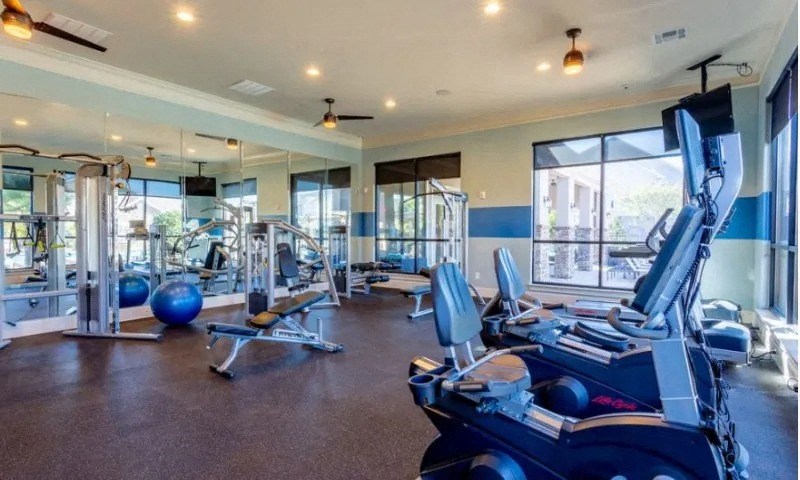 a gym with cardio machines and weights on the floor at Century HomePlace, Prattville, AL 36066