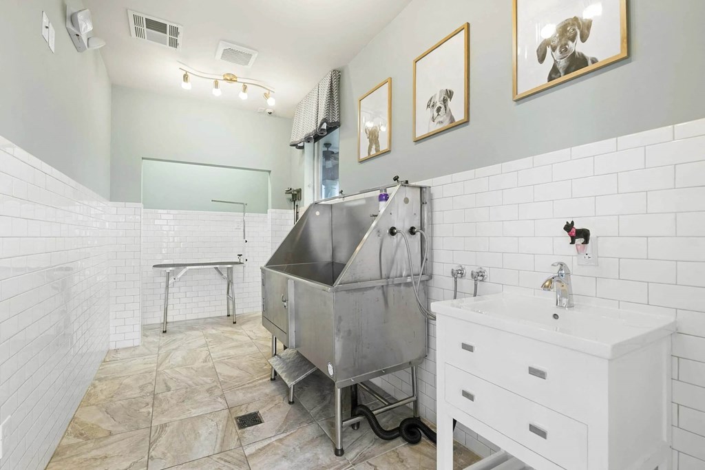 a white bathroom with a stainless steel tub in the middle at Century HomePlace, Alabama, 36066