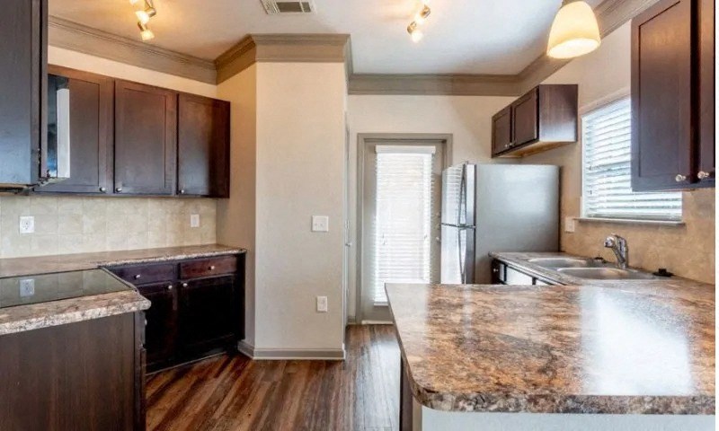 a kitchen with granite counter tops and stainless steel appliances at Century HomePlace, Alabama