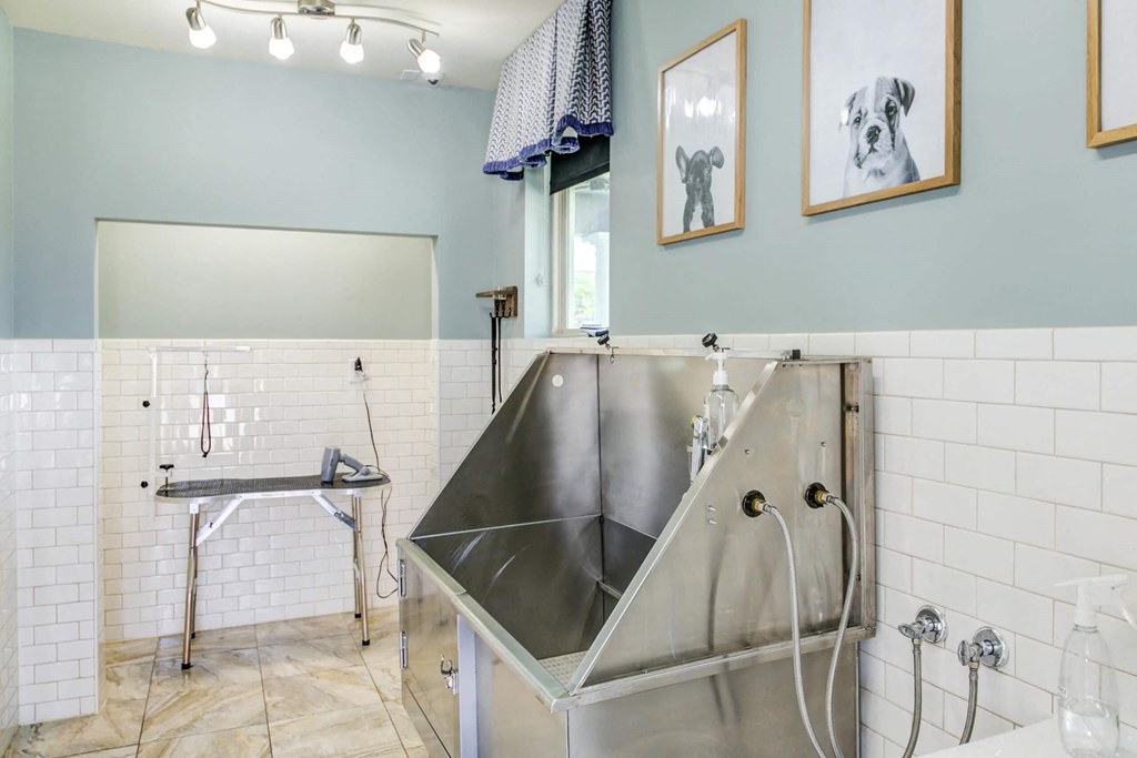 a large stainless steel sink in a bathroom with a shower at Century HomePlace, Prattville Alabama