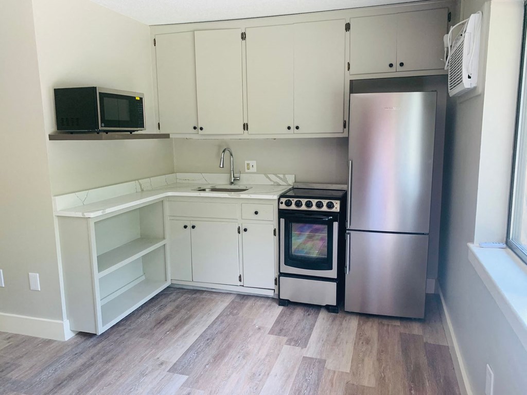 a kitchen with white cabinets and stainless steel appliances at Briarcliff at Quechee, Vermont, 05059