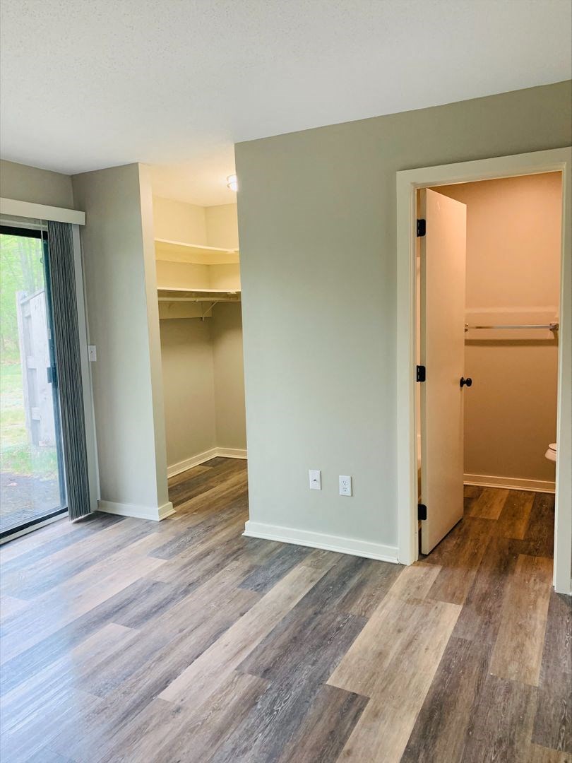 a bedroom with a closet and a sliding glass door at Briarcliff at Quechee, Quechee, VT