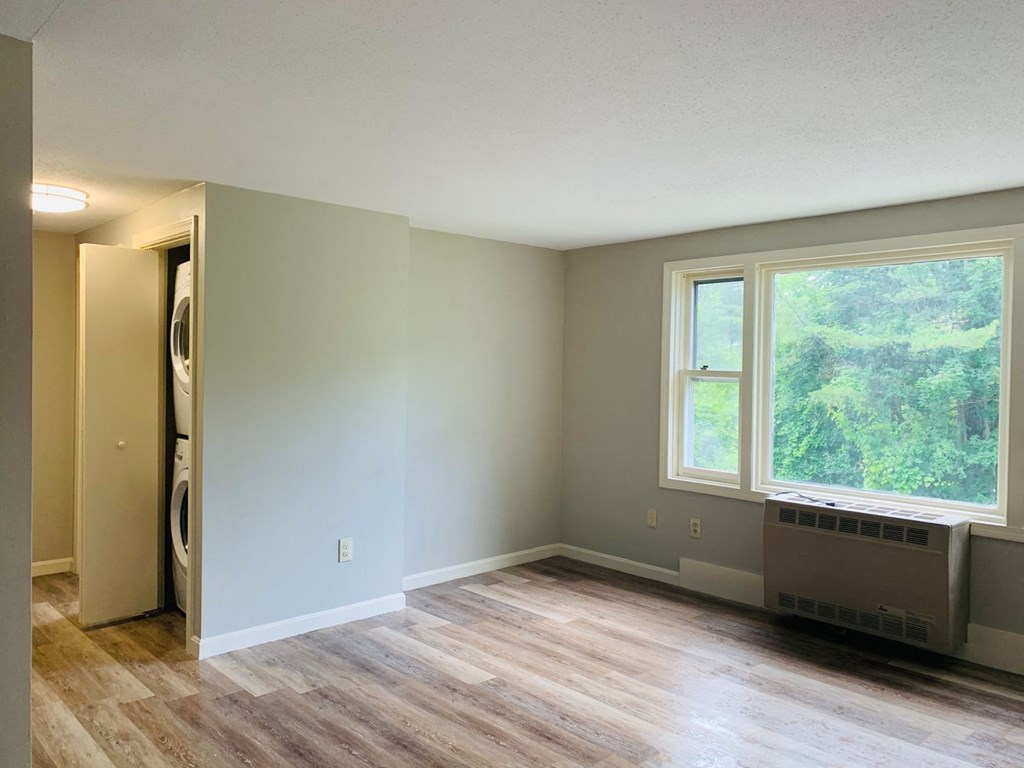 an empty living room with a wood floor and a window at Briarcliff at Quechee, Quechee