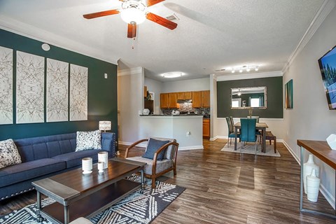 A living room with a dark blue couch and a wooden coffee table.