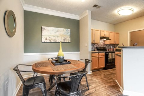 a dining room and kitchen with a table and chairs