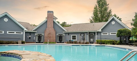 a large swimming pool in front of a house