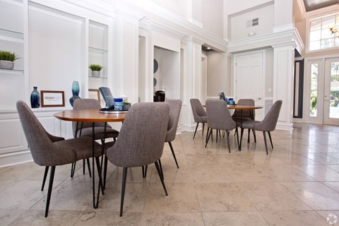 a dining room with tables and chairs and a geometric wallpaper