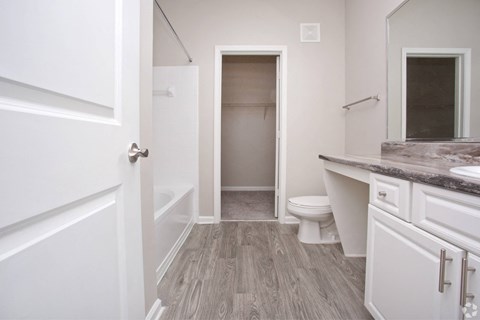 a bathroom with a toilet and a tub and a sink