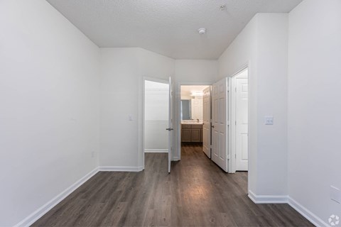 a renovated living room with white walls and wood floors