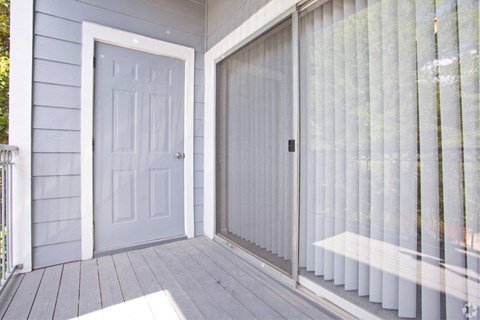 the front porch of a home with a blue door