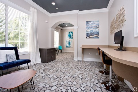 a conference room with a desk and a television