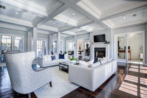 A modern living room with a fireplace and a television.