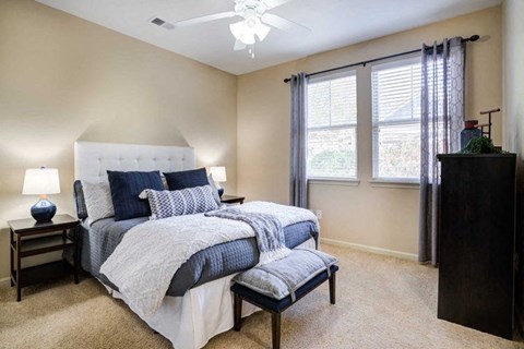 a bedroom with a bed and a chair and a ceiling fan at Century Lakeshore Crossings, Birmingham, 35211