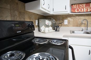 a kitchen with a stove and a sink