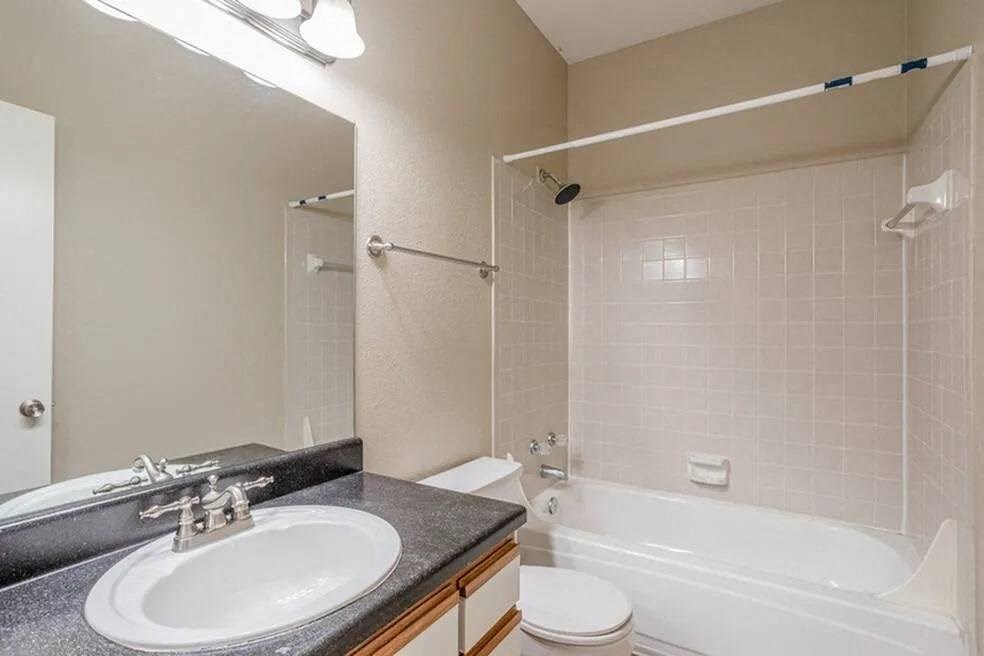 a bathroom with a sink toilet and a tub