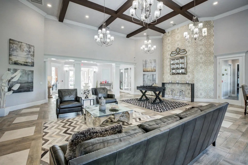 A large, modern living room with a dark leather couch and a fireplace.at Century Ariva, Lakeland, Florida  