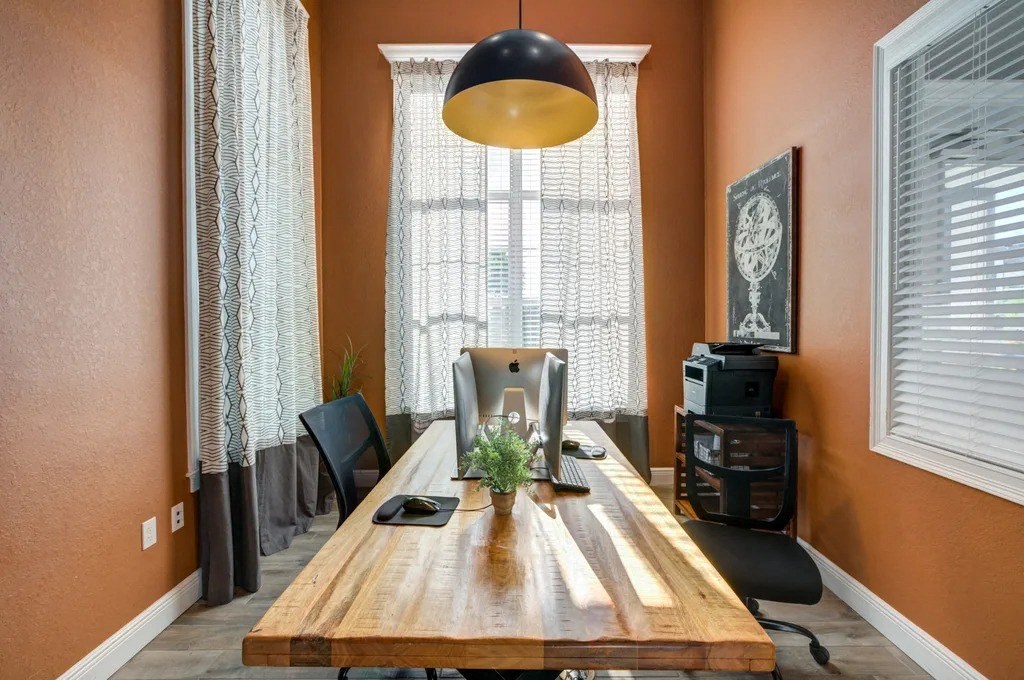 A room with a wooden table and a black lamp.at Century Ariva, Lakeland Florida  