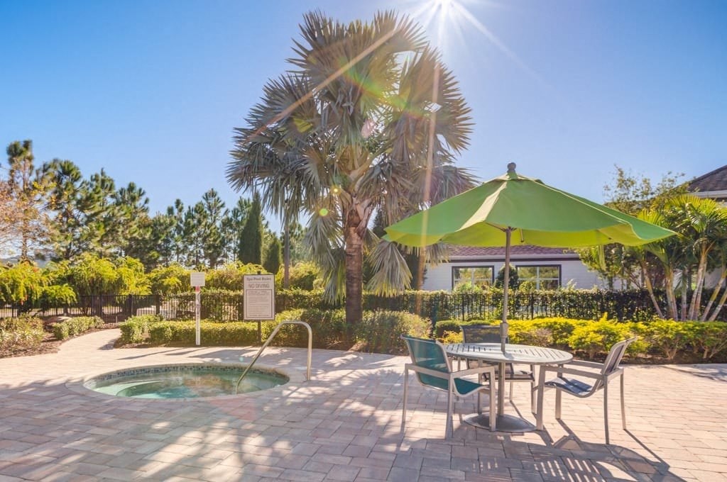 A sunny day at the outdoor seating area with a pool.at Century Ariva, Lakeland  