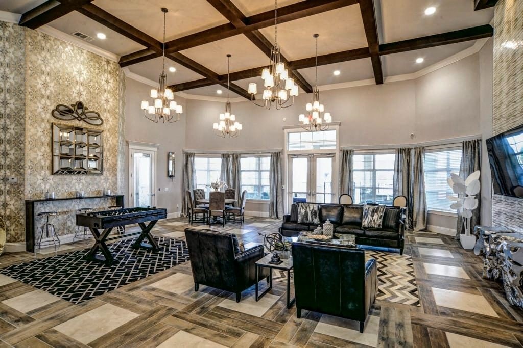 A living room with a black and white checkered rug and a wooden floor.at Century Ariva, Lakeland, 33812  