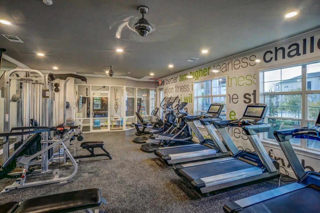 A gym with treadmills, weights, and exercise equipment.at Century Ariva, Lakeland  