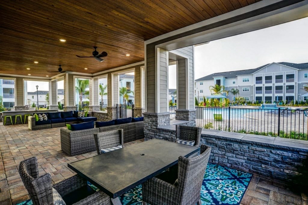 A patio with a table and chairs overlooking a pool.at Century Ariva, Lakeland  