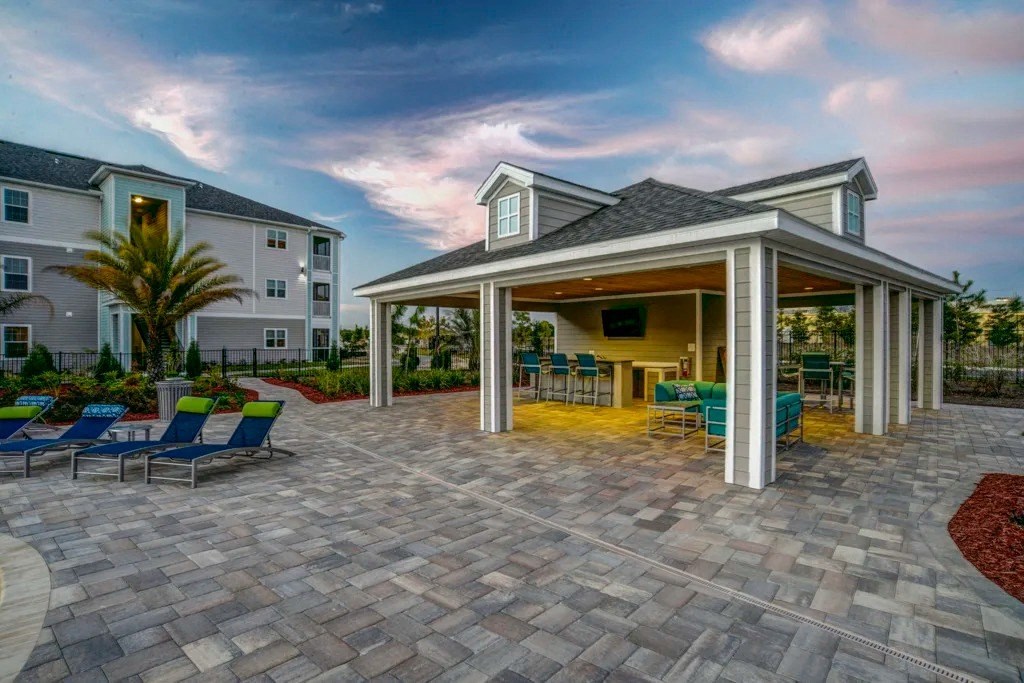 A patio area with a gazebo and chairs is surrounded by apartment buildings.at Century Ariva, Lakeland Florida  