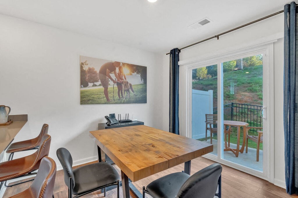 A dining room with a wooden table and chairs.