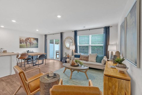 A living room with a sofa, chairs, and a coffee table.