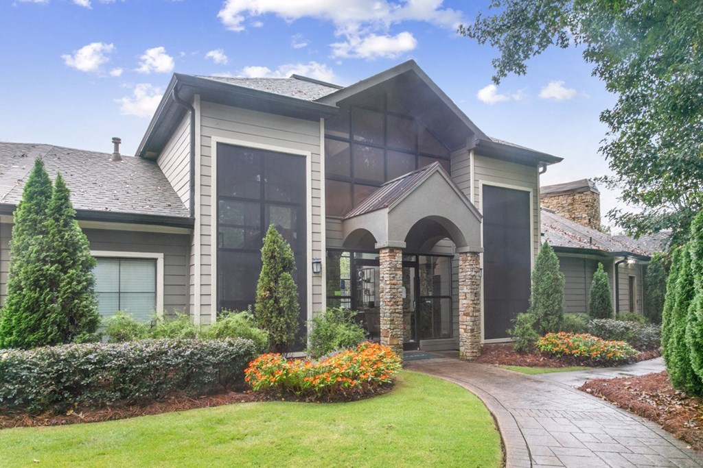 A house with a grey roof and a stone archway entrance at Ridge Crossings Apartments, Hoover, AL 35244