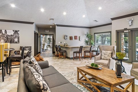 A living room with a grey couch and a wooden coffee table.