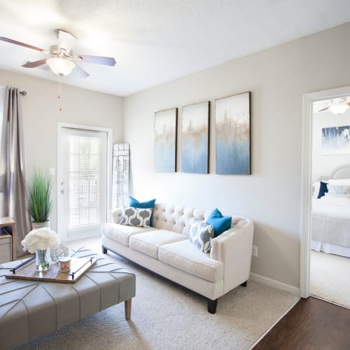A living room with a white couch and a grey coffee table.