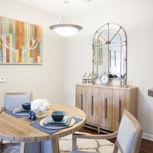 A dining room with a wooden table and chairs.