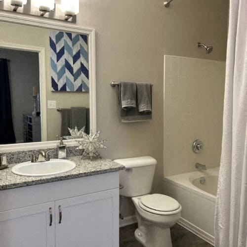 A white toilet sits next to a sink in a bathroom.
