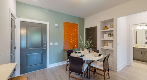 A dining room with a table set for two.