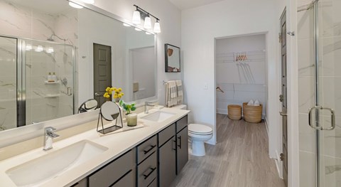 A bathroom with a white sink and a toilet.