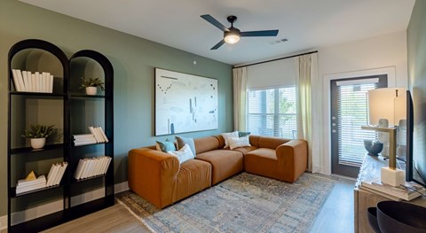 A living room with a brown sofa and a television.