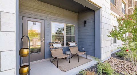 A patio with a couch and chairs is visible through a door.