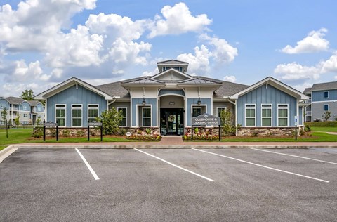 A large building with a parking lot in front of it.