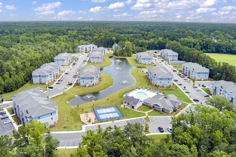 A bird's eye view of a residential complex with a swimming pool and a playground.