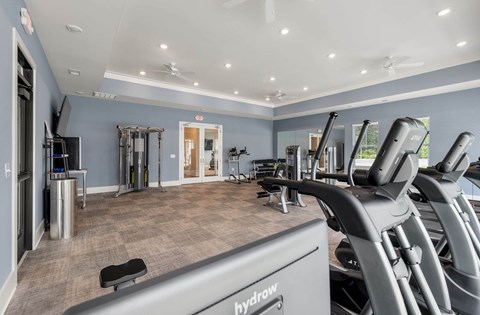 A gym with treadmills and exercise equipment.