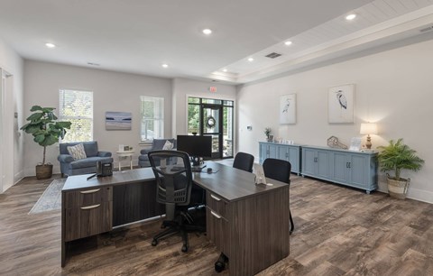 A spacious office with a long desk and chairs.