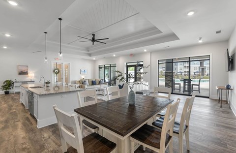 A modern kitchen with a dining table and chairs.
