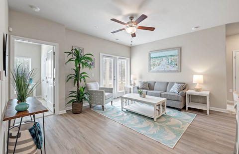A living room with a grey couch and a white coffee table.