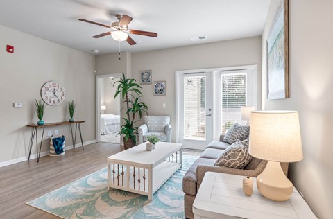 A living room with a white sofa, a white coffee table, and a white lamp.