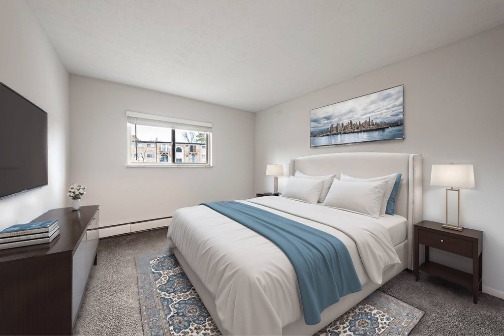 A bedroom with a large bed and a painting on the wall.