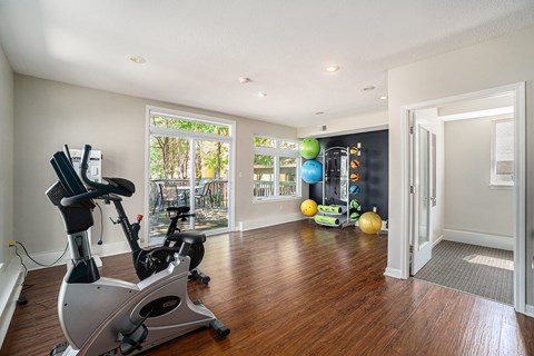 A room with a stationary bike and a treadmill.