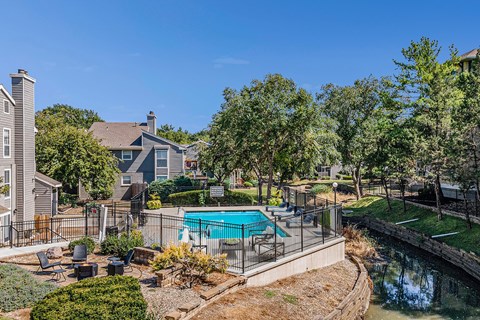 A backyard with a pool and a fence.