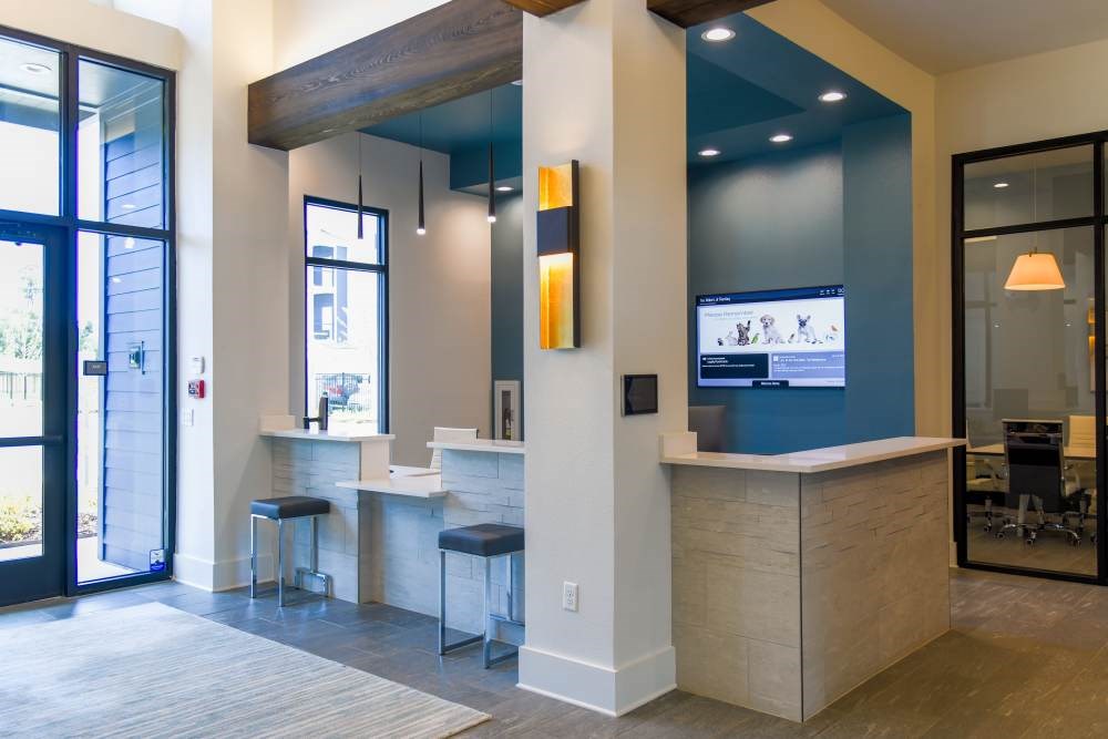 A reception area with a bar and a television.