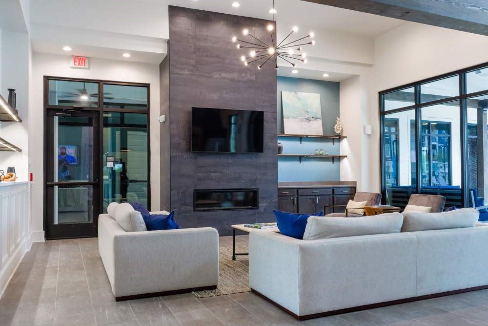A modern living room with a fireplace and a flat screen TV.